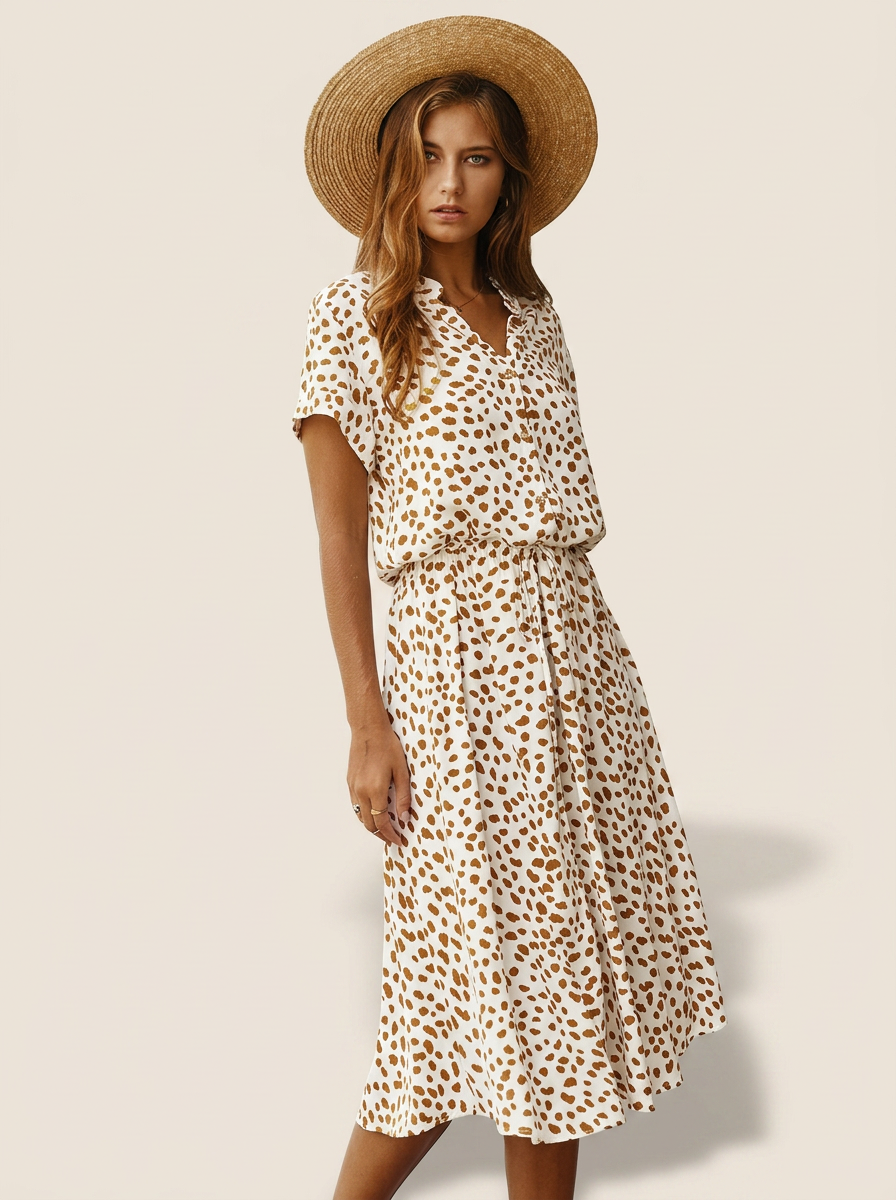 Faelina printed summer dress on beige studio background